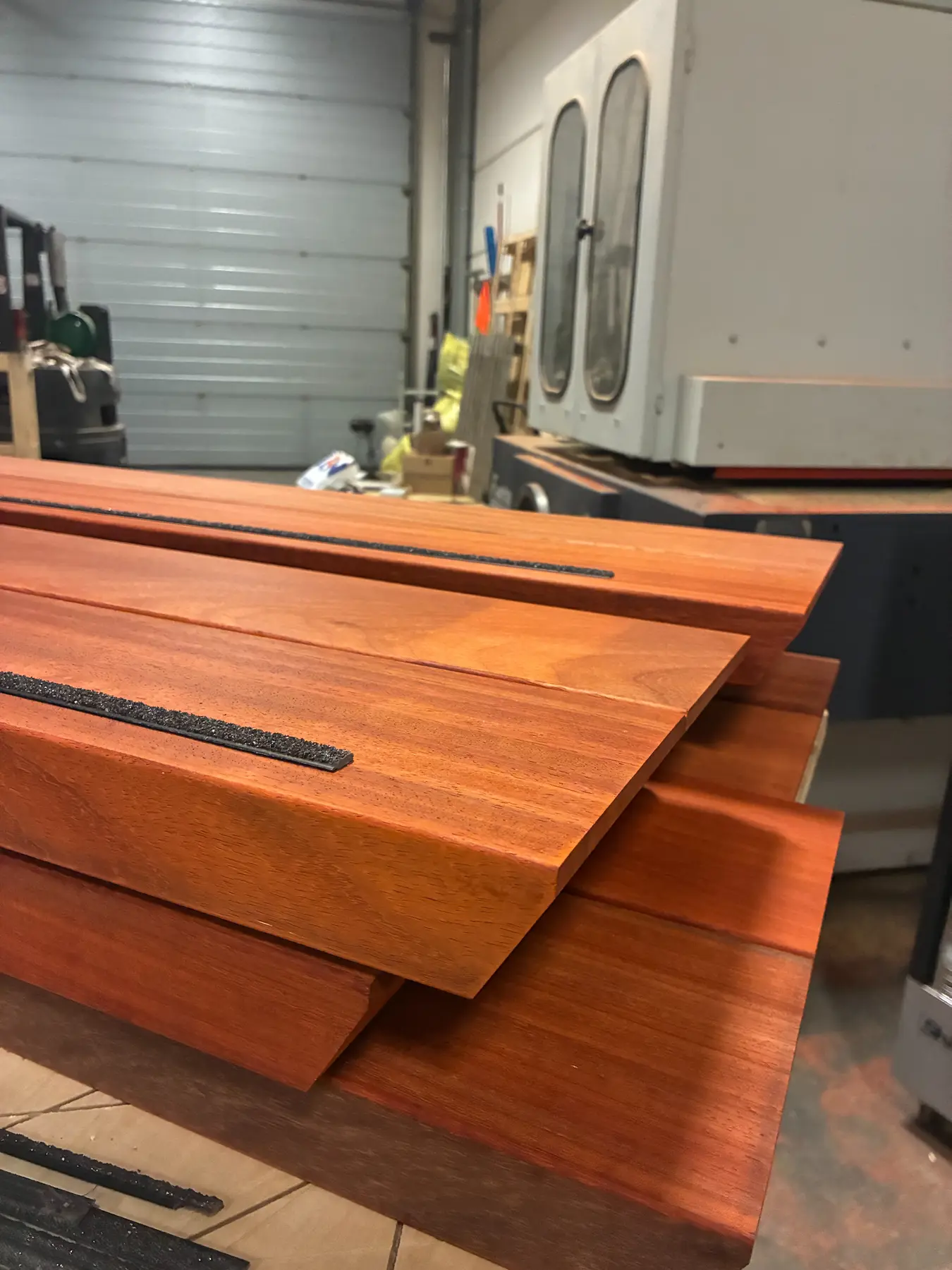 Stacked hardwood stair treads with a milled slot, in the workshop